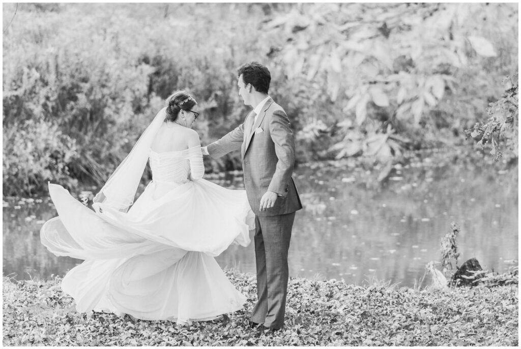 playful bride and groom portrait by lake placid