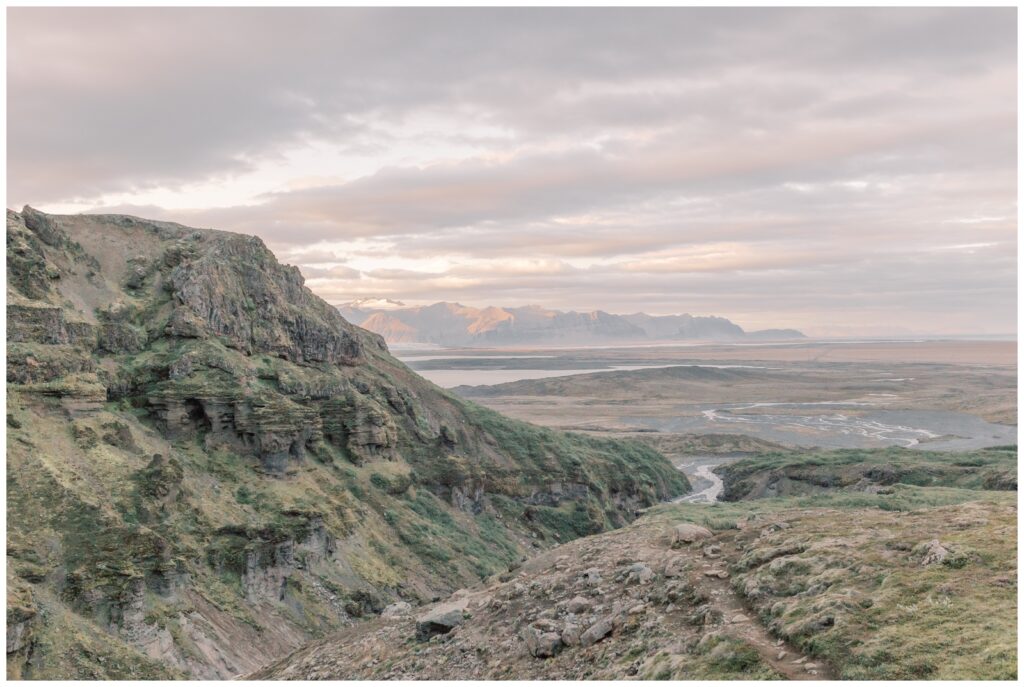 Iceland landscape with mountains in the distance and streams from a waterfall during and Iceland elopement