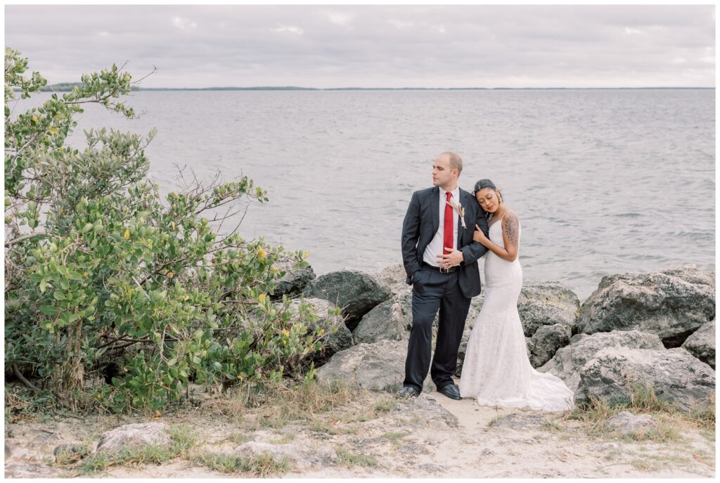 Couple taking in the view of the Gulf shore on their wedding day during the Spring season.
