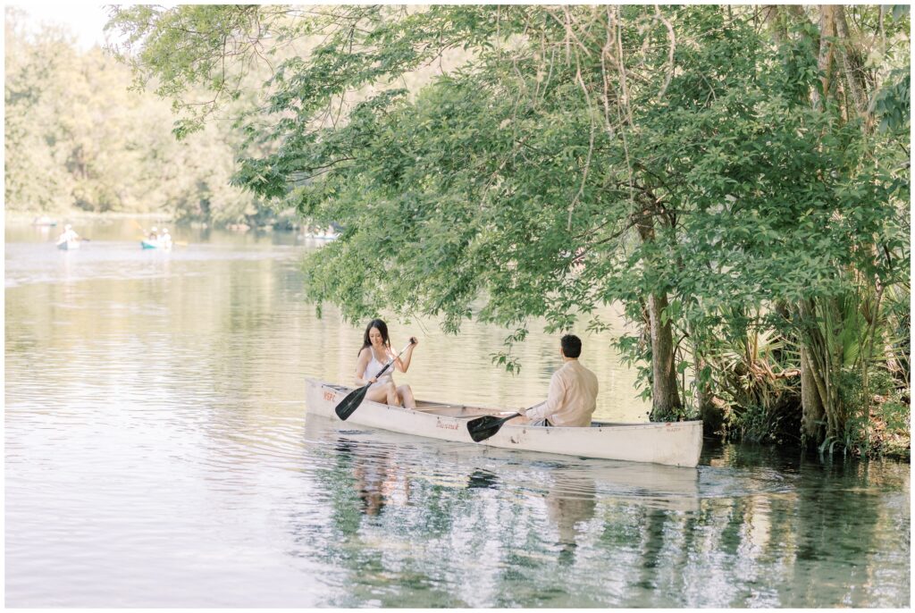 Couple canoeing at Wekiwa Springs State Park in Florida on a sunny day in March.
